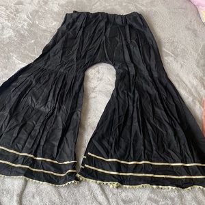 Black cotton flared pants with golden lace